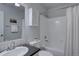 Clean bathroom features a shower-tub combo with a white shower curtain and a white cabinet above the toilet at 1105 Bacchus Dr # F8, Lafayette, CO 80026