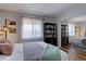 Bright bedroom featuring mirrored closet doors, bookshelf and a large window with sheer curtains at 1105 Bacchus Dr # F8, Lafayette, CO 80026