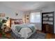 Calming bedroom features natural light, wooden accents, and a comfortable queen sized bed at 1105 Bacchus Dr # F8, Lafayette, CO 80026