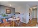 Inviting dining area with modern furniture and adjacent to a kitchen view with wood-style flooring at 1105 Bacchus Dr # F8, Lafayette, CO 80026