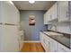 Efficient kitchen showcasing white appliances and cabinets paired with dark countertops at 1105 Bacchus Dr # F8, Lafayette, CO 80026