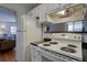 A functional kitchen includes a white refrigerator, stove oven, and view to the living room at 1105 Bacchus Dr # F8, Lafayette, CO 80026