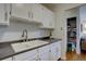 Well-lit kitchen offering bright white cabinetry, dark countertops, and storage solutions at 1105 Bacchus Dr # F8, Lafayette, CO 80026