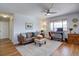 Bright living room with a home office setup and comfortable seating area; wood floors throughout at 1105 Bacchus Dr # F8, Lafayette, CO 80026