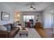 Bright living room with a home office, a ceiling fan, and a view from the window; wood floors throughout at 1105 Bacchus Dr # F8, Lafayette, CO 80026