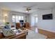 Cozy living room with natural light, featuring a workstation and a TV; wood floors throughout at 1105 Bacchus Dr # F8, Lafayette, CO 80026