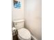 Powder room with standard toilet and white walls with colorful print hanging above at 1842 Canyon Blvd # 105, Boulder, CO 80302