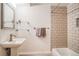 Clean bathroom with pedestal sink, subway tile, chrome fixtures, and glass shelving at 1842 Canyon Blvd # 105, Boulder, CO 80302