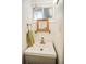Small bathroom vanity with light grey wood grain cabinets, sink, window, mirror and towel at 1842 Canyon Blvd # 105, Boulder, CO 80302