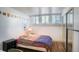 Modest bedroom with wood floors, closet, three windows, and string of photos hanging above at 1842 Canyon Blvd # 105, Boulder, CO 80302
