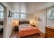 Comfortable bedroom with a wood accent headboard, carpet, and twin nightstands with lamps flanking each side at 1842 Canyon Blvd # 105, Boulder, CO 80302