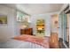 Bedroom with natural light, featuring a yellow shelf and a view of the closet through the sliding doors at 1842 Canyon Blvd # 105, Boulder, CO 80302