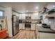 Well-equipped kitchen featuring stainless steel appliances, white cabinets, and ample counter space at 1842 Canyon Blvd # 105, Boulder, CO 80302
