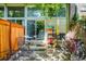 Relaxing patio with a dining area, a metal rack, brick accents, and shady trees, ideal for outdoor living at 1842 Canyon Blvd # 105, Boulder, CO 80302