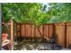 Enclosed patio features a privacy fence, brick accents, and comfortable seating, creating an outdoor retreat at 1842 Canyon Blvd # 105, Boulder, CO 80302