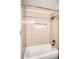 Bathtub with white subway tile surround, niche with honeycomb tile detail, and bronze fixtures at 1842 Canyon Blvd # 105, Boulder, CO 80302