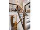Modern staircase with hardwood treads and risers, black metal railings, and natural light. Dining room at top of steps at 1842 Canyon Blvd # 105, Boulder, CO 80302