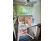 A modern staircase leading to an outdoor patio with a small seating area with a white metal bistro set at 1842 Canyon Blvd # 105, Boulder, CO 80302