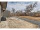 Backyard featuring a concrete patio area, a gravel border, and a wooden fence at 12932 E Elgin Pl, Denver, CO 80239