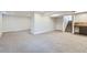 Spacious finished basement featuring plush carpeting and access to the stairs and a rustic wet bar area at 12932 E Elgin Pl, Denver, CO 80239