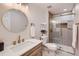 Elegant bathroom featuring modern fixtures, a glass-enclosed shower, and marble accents at 12932 E Elgin Pl, Denver, CO 80239