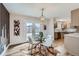 Dining area with glass table, modern chairs, and doors that lead to the backyard at 12932 E Elgin Pl, Denver, CO 80239