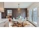 Dining area featuring a decorative accent wall, modern chairs, and stylish lighting at 12932 E Elgin Pl, Denver, CO 80239