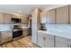 Modern kitchen with stainless steel appliances, ample counter space and natural wood cabinets at 12932 E Elgin Pl, Denver, CO 80239