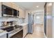 Bright kitchen featuring stainless steel appliances, light wood cabinets, and modern countertops at 12932 E Elgin Pl, Denver, CO 80239