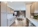 Well-appointed kitchen with stainless appliances opening into a dining area at 12932 E Elgin Pl, Denver, CO 80239