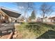Spacious backyard featuring a covered patio, trampoline, playground, and a well-maintained lawn at 3395 W Union Ave, Englewood, CO 80110