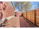 View of the backyard featuring a red and white shed and a wooden fence, enhancing privacy and storage at 3395 W Union Ave, Englewood, CO 80110
