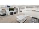 Spacious basement area featuring built-in shelving, a comfortable seating area, and neutral-toned carpeting for versatile use at 3395 W Union Ave, Englewood, CO 80110