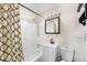Cozy bathroom features a shower-tub combo with a decorative curtain, a modern vanity, and a mirrored medicine cabinet at 3395 W Union Ave, Englewood, CO 80110