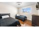 Bright bedroom with hardwood floors and two twin beds, great for Gathering or guests at 3395 W Union Ave, Englewood, CO 80110