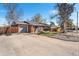 Charming home with a well-maintained lawn, driveway, and a basketball hoop adding curb appeal at 3395 W Union Ave, Englewood, CO 80110