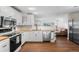 Modern kitchen featuring white cabinets, hardwood floors, stainless appliances at 3395 W Union Ave, Englewood, CO 80110