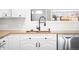 Close-up of the kitchen sink area with modern fixtures and countertops at 3395 W Union Ave, Englewood, CO 80110