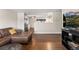 Living room view towards the kitchen featuring hardwood floors at 3395 W Union Ave, Englewood, CO 80110