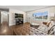 Cozy living room with hardwood floors, a comfortable leather sofa, and ample natural light at 3395 W Union Ave, Englewood, CO 80110
