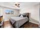 Comfortable main bedroom featuring a large bed, hardwood floors, and a bright window at 3395 W Union Ave, Englewood, CO 80110