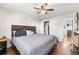 Spacious main bedroom featuring a large bed, hardwood floors, and a ceiling fan at 3395 W Union Ave, Englewood, CO 80110