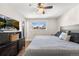 Comfortable main bedroom featuring a large bed, hardwood floors, and natural lighting at 3395 W Union Ave, Englewood, CO 80110