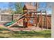 Close-up view of the wooden playground with a slide, swings, and climbing features at 3395 W Union Ave, Englewood, CO 80110