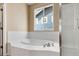 Bright bathroom features a soaking tub, and window at 13262 Elizabeth St, Thornton, CO 80241