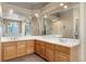 Bright bathroom features a double sink vanity with white tile countertop and a large mirror at 13262 Elizabeth St, Thornton, CO 80241