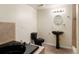 Bright bathroom featuring a black toilet, pedestal sink and tub with stylish tile surround at 13262 Elizabeth St, Thornton, CO 80241
