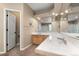 Bright bathroom features a double sink vanity with white tile countertop and walk-in shower at 13262 Elizabeth St, Thornton, CO 80241