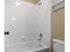 Clean white tiled shower and bathtub with neutral paint at 13262 Elizabeth St, Thornton, CO 80241