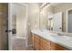 Bright bathroom with a double sink vanity, neutral walls and carpet at 13262 Elizabeth St, Thornton, CO 80241